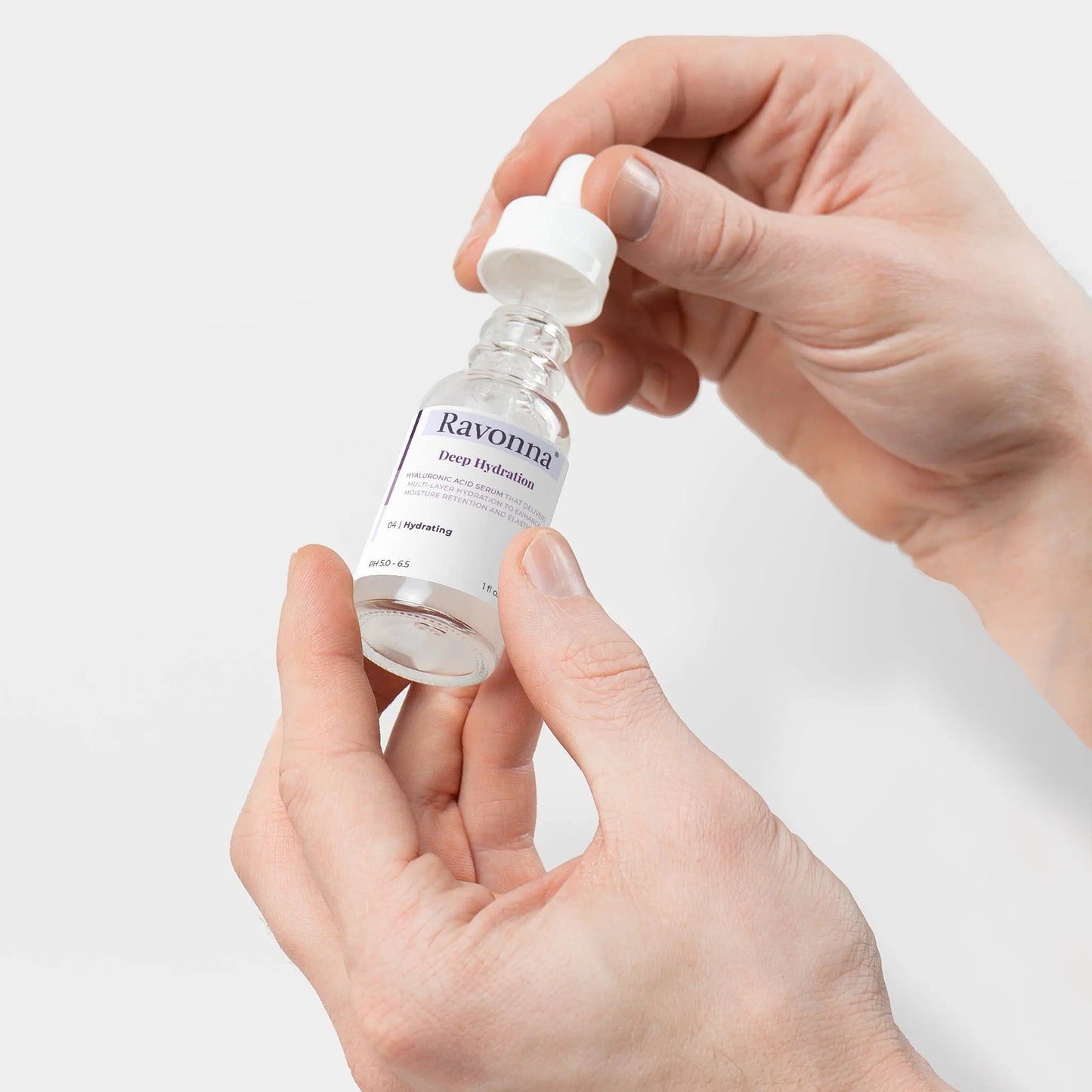 Deep Hydration Serum bottle on open hand - Ravonna
