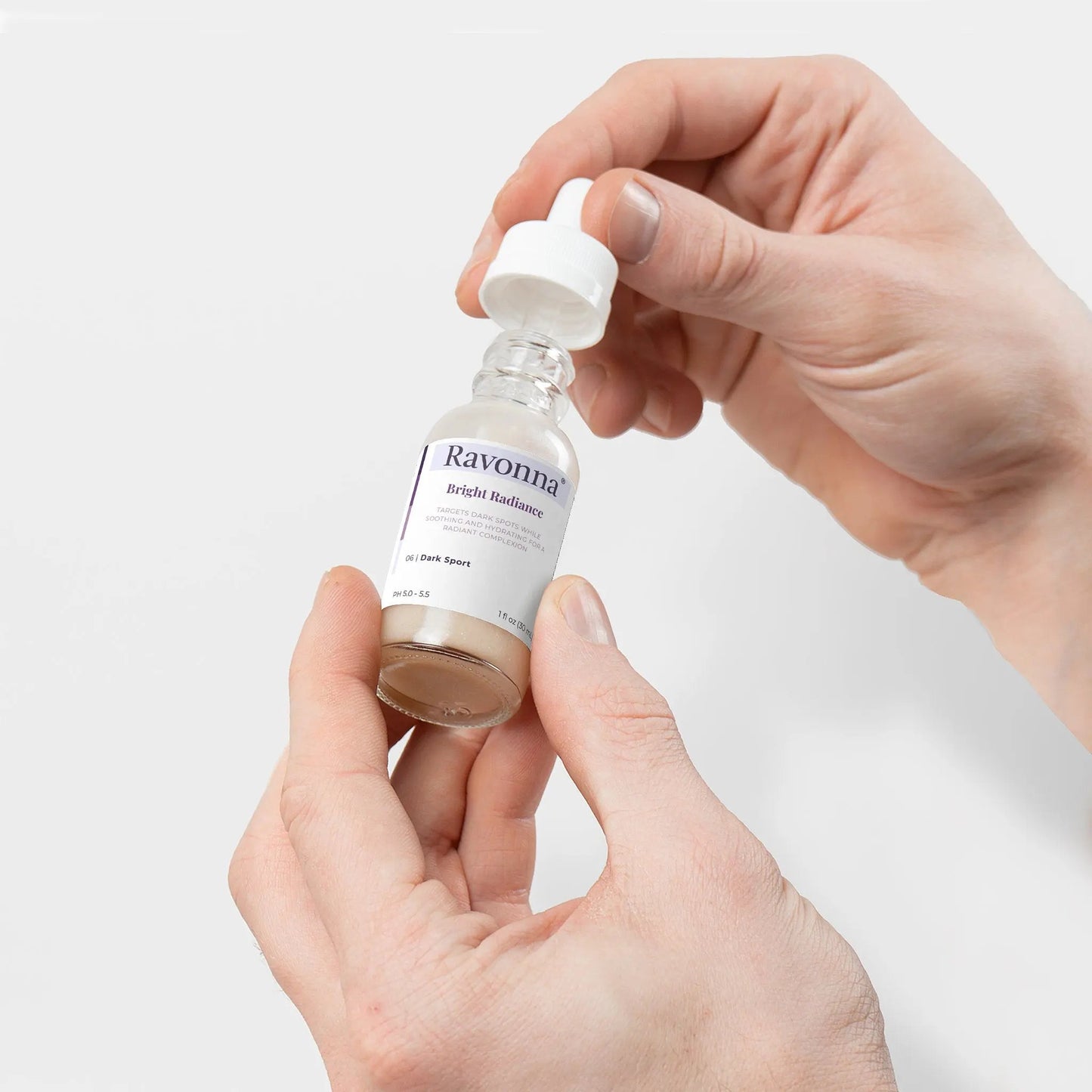 Holding Bright Radiance Serum bottle – Ravonna