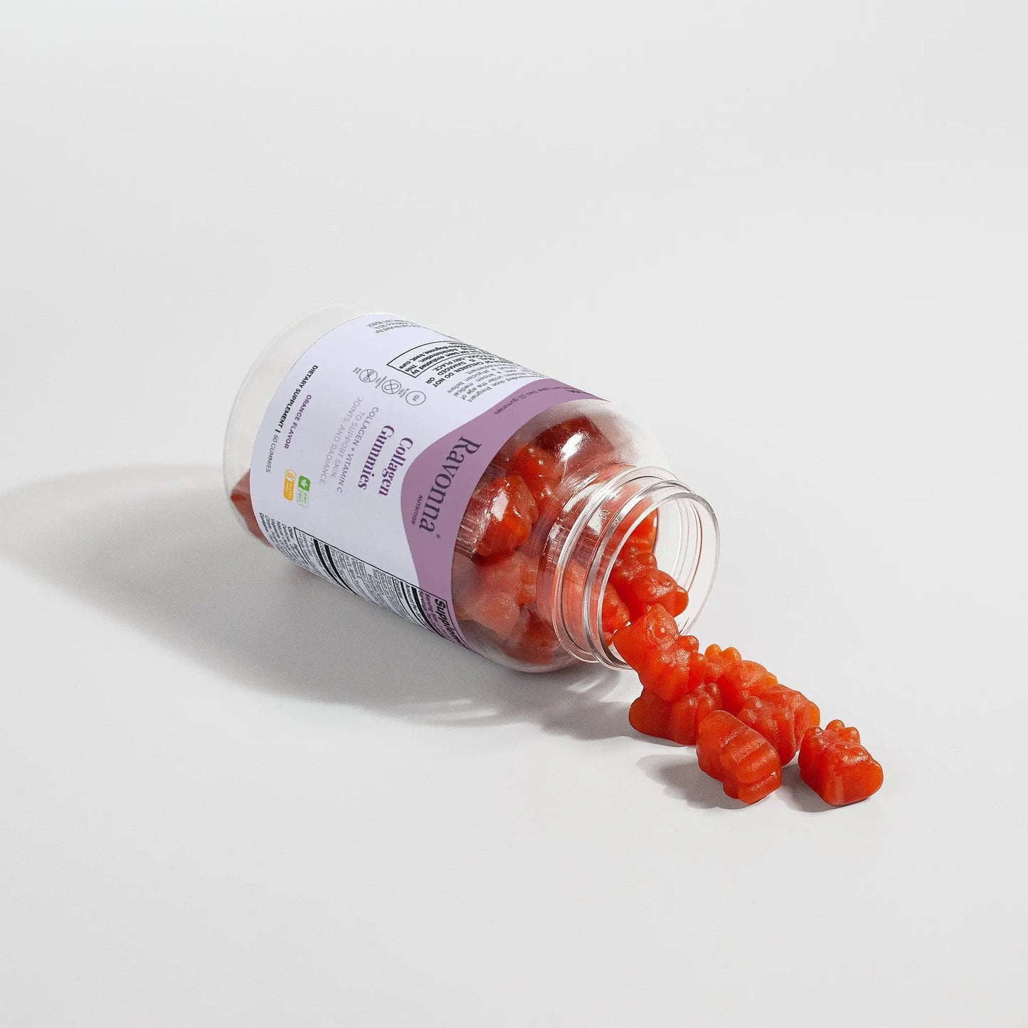 Glow Gummies spilling from open bottle on white background – Ravonna