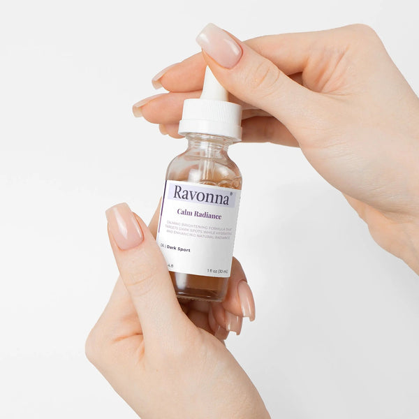 Hands holding Calm Radiance Serum bottle – Ravonna