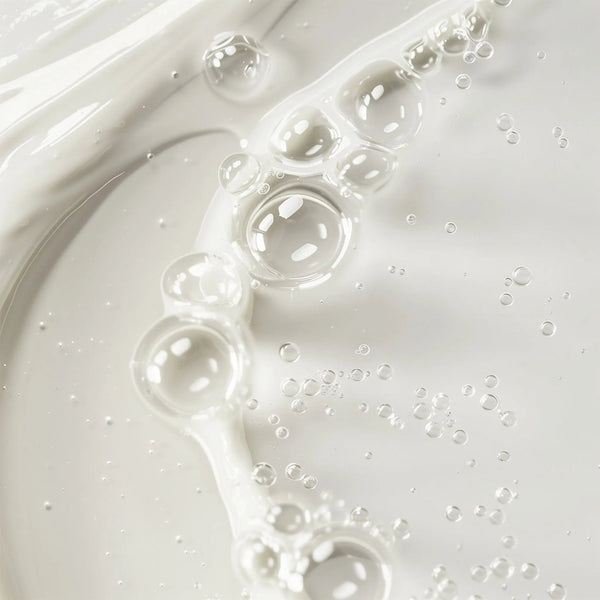 Close-up texture of Gentle Balancing Toner with clear liquid drops – Ravonna