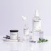 Ravonna skincare products including a jar, bottle with dropper, and other bottles on a light gray background.