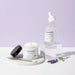 Ravonna skincare products including a jar, dropper bottle, and cream on a light purple background.