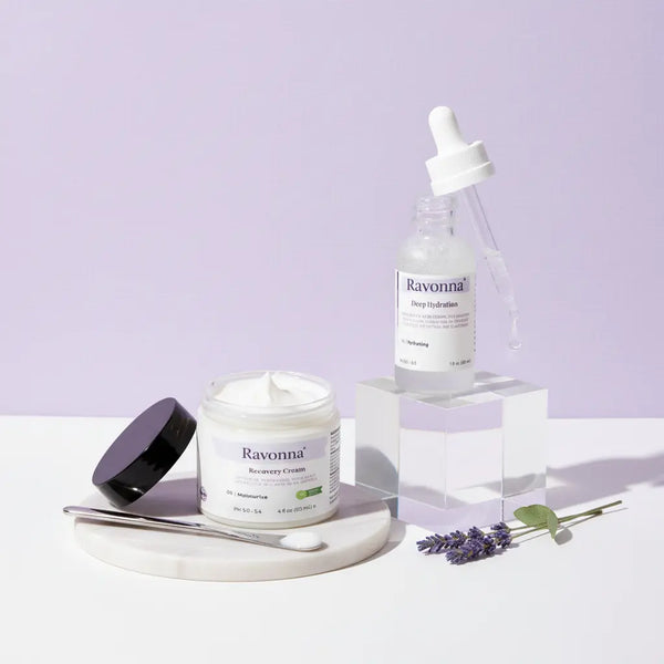 Ravonna skincare products including a jar, dropper bottle, and cream on a light purple background.